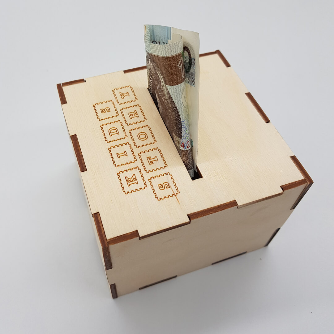 drewniana skarbonka z logo przedszkola